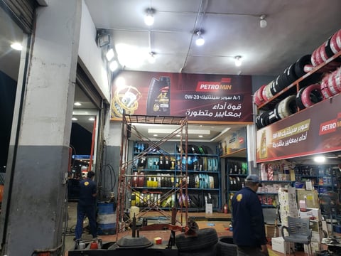 An automotive service shop interior with shelves of car products