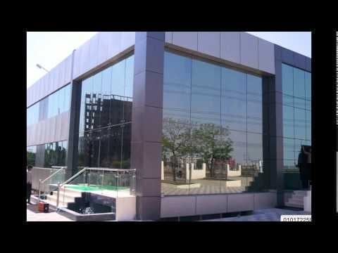 Modern glass and metal building facade with reflections