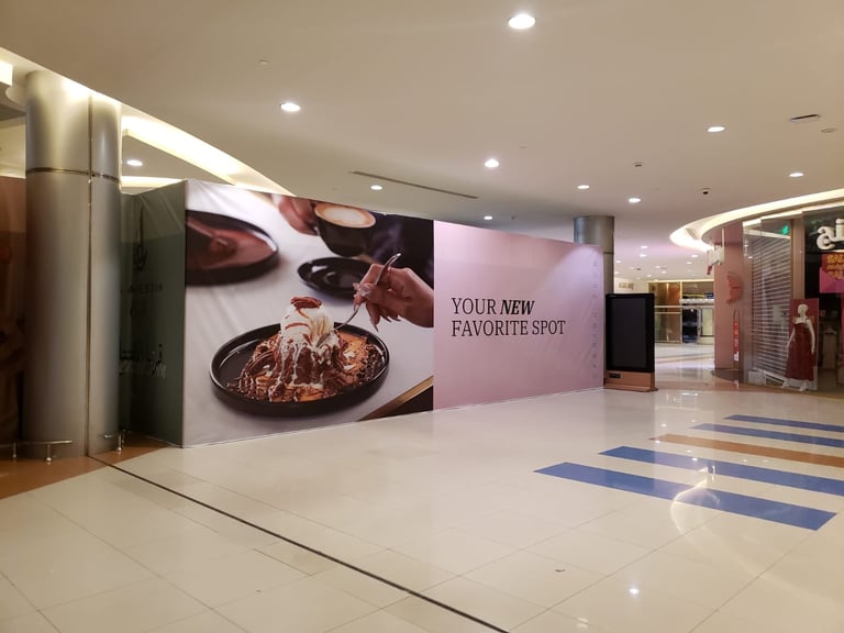 Modern mall corridor with large food advertisement banner